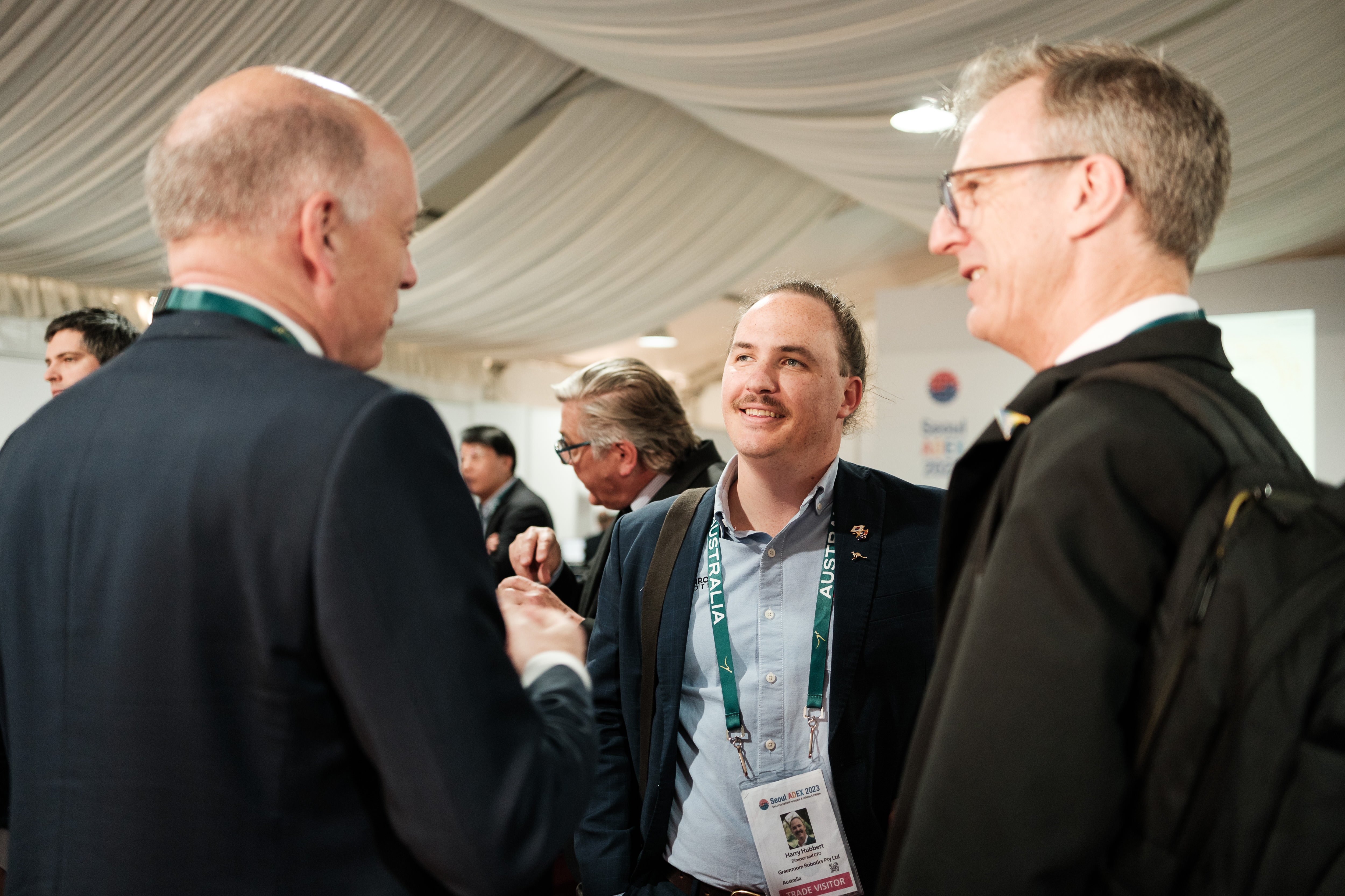 Harry Hubbert talking to two attendees of ADEX 2023